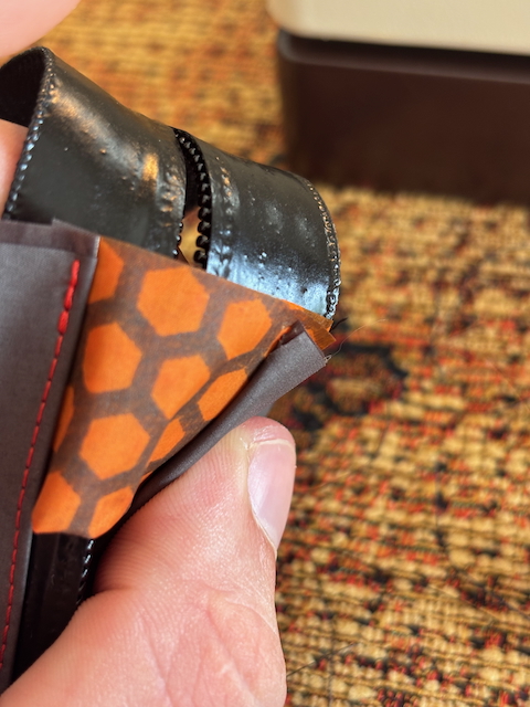 Close up of the zipper garage with the bottom panel missing some stitches.